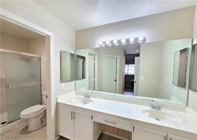 2035 E Warm Springs Rd Unit 1017, Las Vegas, NV 89119 - full bath featuring toilet, a shower stall, double vanity, and tile patterned flooring