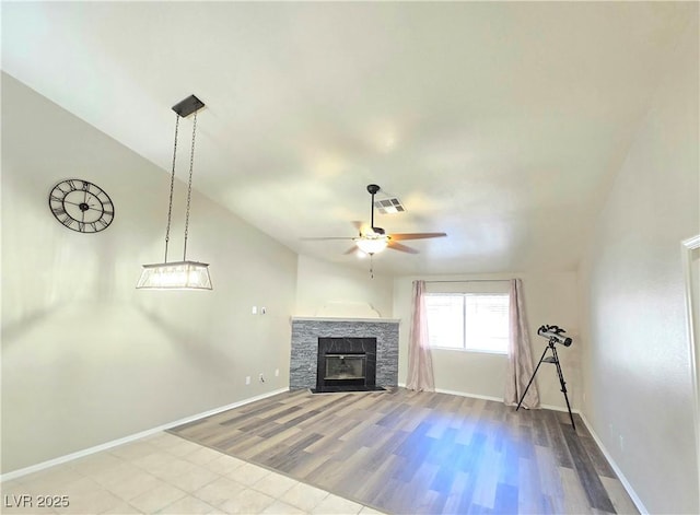 2035 E Warm Springs Rd Unit 1017, Las Vegas, NV 89119 - unfurnished living room with ceiling fan, wood finished floors, baseboards, a fireplace, and vaulted ceiling