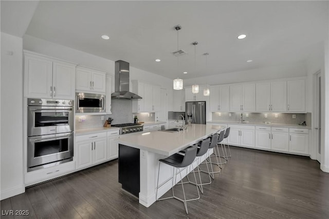 362 Port Reggio St, Las Vegas, NV 89138 - kitchen with wall chimney exhaust hood, stainless steel appliances, a sink, tasteful backsplash, and white cabinetry