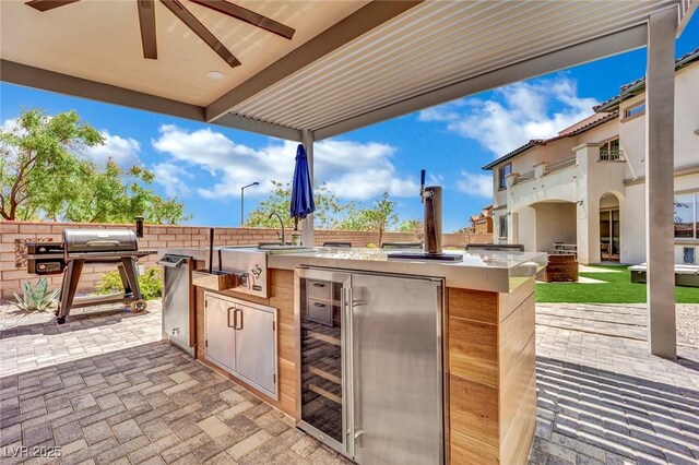 362 Port Reggio St, Las Vegas, NV 89138 - view of patio featuring beverage cooler, an outdoor kitchen, a sink, and ceiling fan