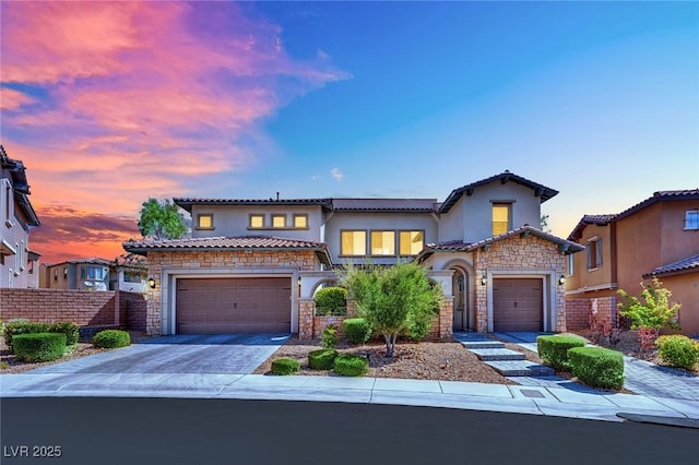 362 Port Reggio St, Las Vegas, NV 89138 - mediterranean / spanish home with stone siding, stucco siding, a tile roof, and an attached garage