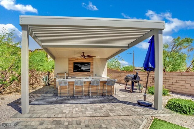 362 Port Reggio St, Las Vegas, NV 89138 - fenced backyard featuring exterior bar, a ceiling fan, and a patio area