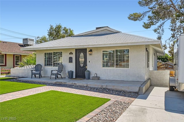 615 D Ave, Boulder City, NV 89005 - bungalow-style house with a front lawn, stucco siding, and a shingled roof