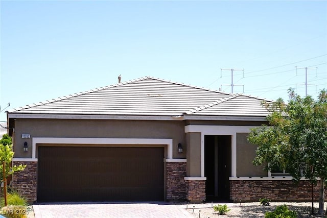 10262 Havasu Falls St, Las Vegas, NV 89141 - view of front of property with stone siding, stucco siding, a garage, and a tiled roof