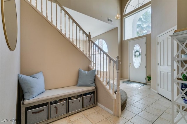 2090 Eaglepath Cir, Henderson, NV 89074 - foyer entrance featuring stairway, a high ceiling, light tile patterned floors, and baseboards