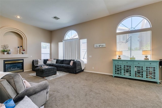 2090 Eaglepath Cir, Henderson, NV 89074 - living room featuring carpet flooring, a glass covered fireplace, and baseboards
