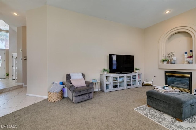 2090 Eaglepath Cir, Henderson, NV 89074 - carpeted living area with recessed lighting, tile patterned flooring, a glass covered fireplace, and baseboards