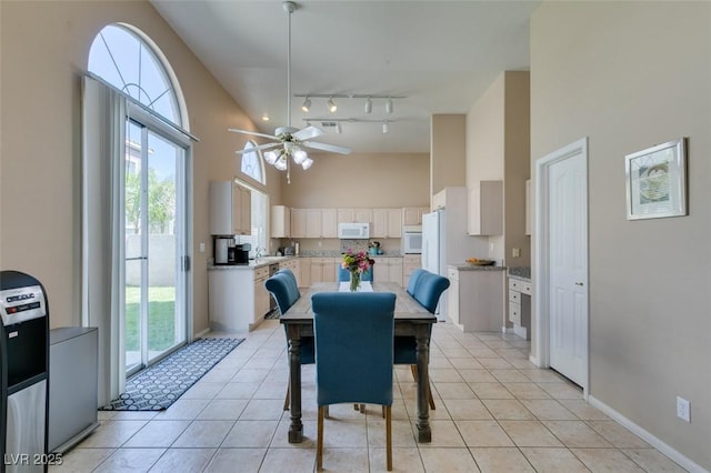 2090 Eaglepath Cir, Henderson, NV 89074 - dining area with high vaulted ceiling, ceiling fan, healthy amount of natural light, and light tile patterned floors