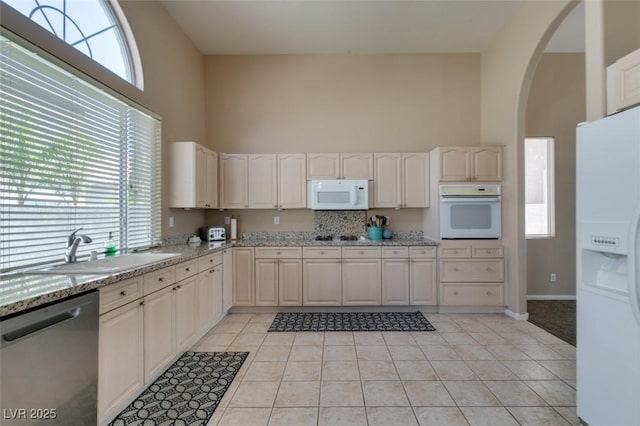 2090 Eaglepath Cir, Henderson, NV 89074 - kitchen with white appliances, a high ceiling, a sink, and healthy amount of natural light