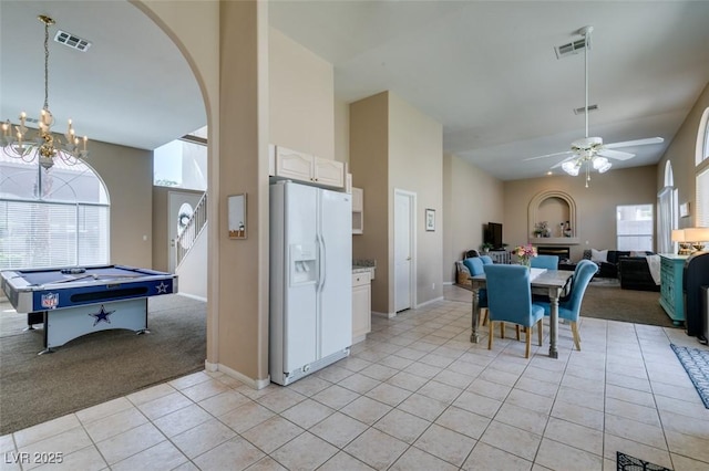 2090 Eaglepath Cir, Henderson, NV 89074 - dining room with light tile patterned flooring, a ceiling fan, a chandelier, baseboards, and light colored carpet