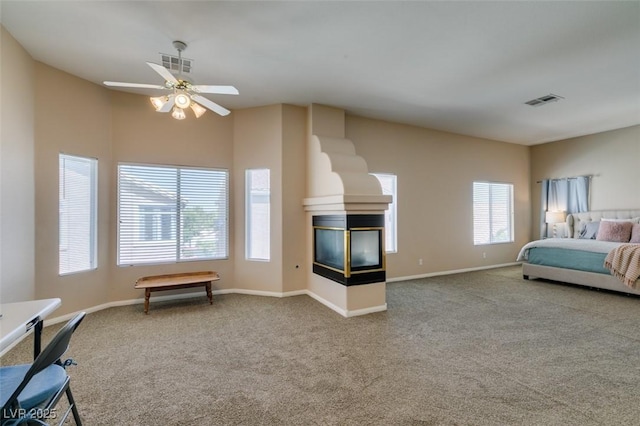 2090 Eaglepath Cir, Henderson, NV 89074 - bedroom featuring carpet, a multi sided fireplace, baseboards, and ceiling fan