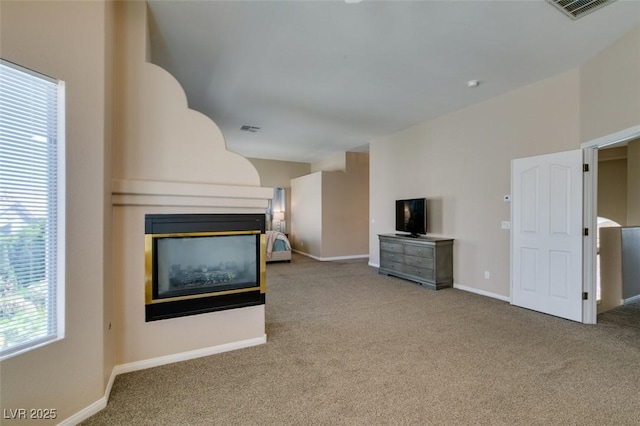 2090 Eaglepath Cir, Henderson, NV 89074 - unfurnished living room featuring carpet, a multi sided fireplace, and baseboards