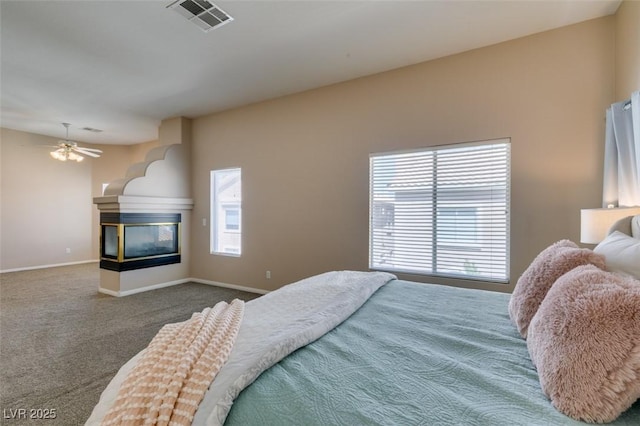 2090 Eaglepath Cir, Henderson, NV 89074 - bedroom featuring a multi sided fireplace, carpet, and baseboards