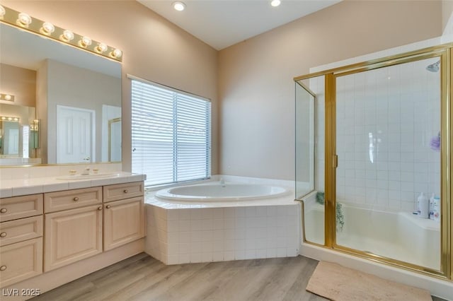2090 Eaglepath Cir, Henderson, NV 89074 - full bathroom featuring vanity, a bath, a stall shower, wood finished floors, and recessed lighting