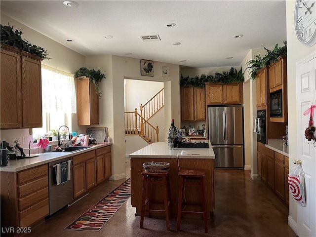 5043 Gable Crest Ct, Las Vegas, NV 89141 - kitchen with black appliances, brown cabinetry, light countertops, a kitchen island, and concrete floors