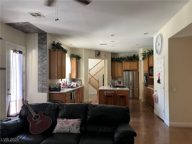5043 Gable Crest Ct, Las Vegas, NV 89141 - kitchen with black appliances, open floor plan, healthy amount of natural light, and brown cabinetry