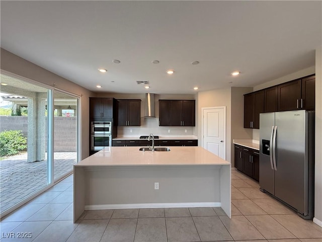 2620 Tolmezzo St, Henderson, NV 89044 - kitchen featuring stainless steel appliances, wall chimney range hood, a sink, dark brown cabinetry, and light countertops