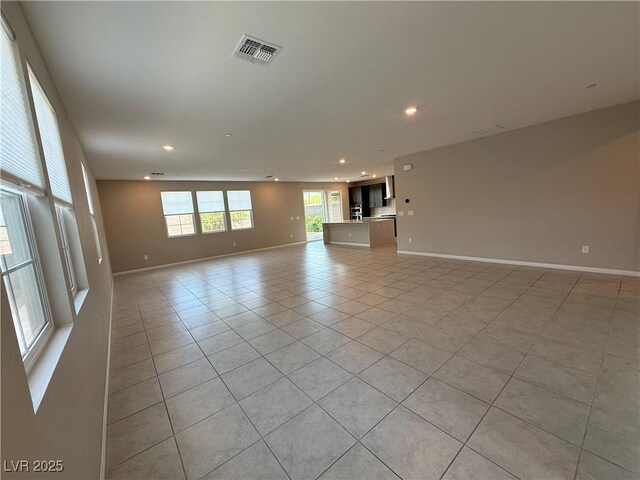 2620 Tolmezzo St, Henderson, NV 89044 - unfurnished living room with light tile patterned flooring, baseboards, and recessed lighting