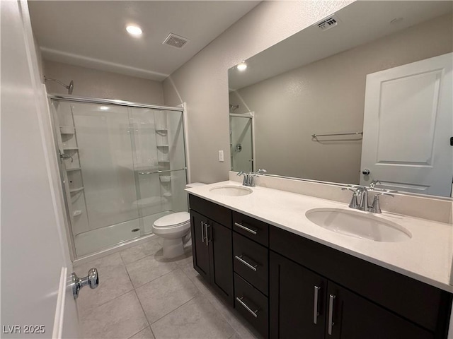 2620 Tolmezzo St, Henderson, NV 89044 - full bathroom with a shower stall, toilet, double vanity, and tile patterned flooring