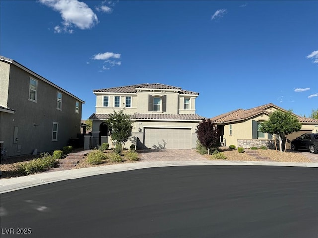 2620 Tolmezzo St, Henderson, NV 89044 - mediterranean / spanish home with stucco siding, a tile roof, an attached garage, and driveway