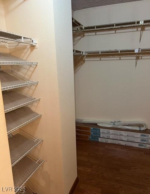 3930 University Center Dr Unit 612, Las Vegas, NV 89119 - walk in closet featuring wood finished floors