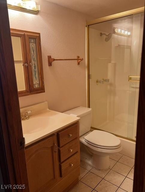 3930 University Center Dr Unit 612, Las Vegas, NV 89119 - full bath featuring vanity, a shower with door, toilet, and tile patterned floors