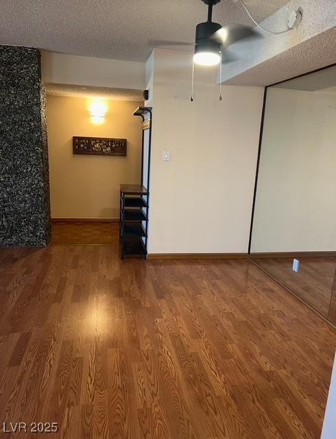 3930 University Center Dr Unit 612, Las Vegas, NV 89119 - unfurnished room featuring ceiling fan, wood finished floors, a textured ceiling, and baseboards