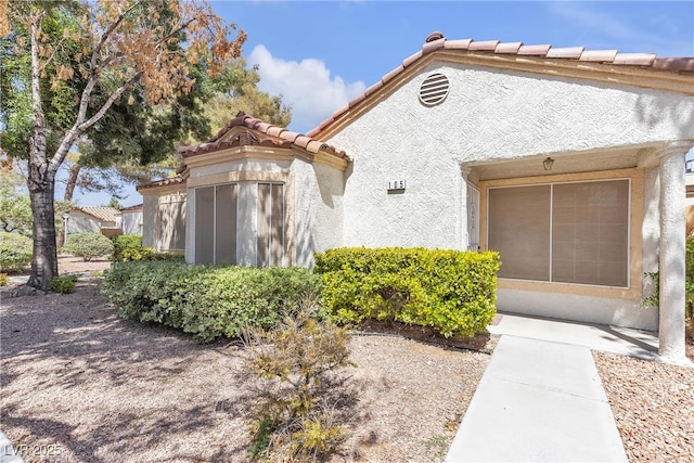 5400 Paul Kurtz Way Unit 105, Las Vegas, NV 89108 - view of front of property featuring a tile roof and stucco siding