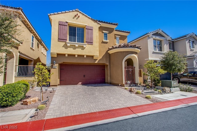 1794 Morro Vista Dr, Las Vegas, NV 89135 - mediterranean / spanish home with a garage, stucco siding, a tile roof, and decorative driveway