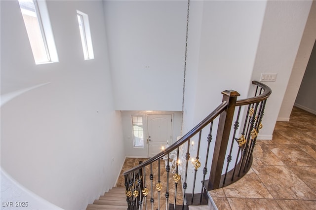 1794 Morro Vista Dr, Las Vegas, NV 89135 - stairway with a towering ceiling and baseboards