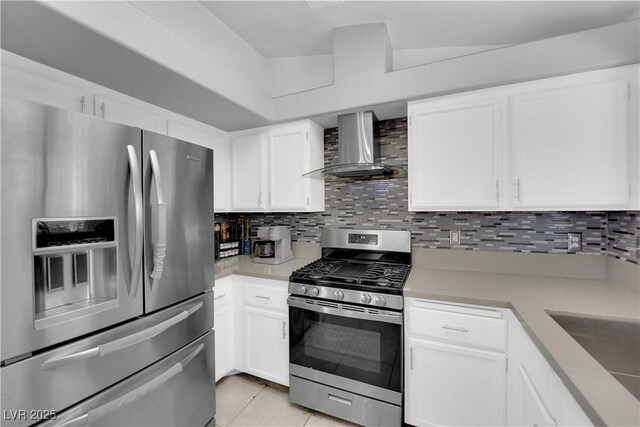 3905 Blairmoor St, North Las Vegas, NV 89032 - kitchen featuring appliances with stainless steel finishes, wall chimney range hood, light countertops, white cabinets, and backsplash
