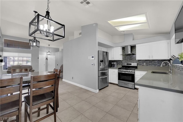 3905 Blairmoor St, North Las Vegas, NV 89032 - kitchen featuring stainless steel appliances, wall chimney range hood, a sink, a chandelier, and light tile patterned floors