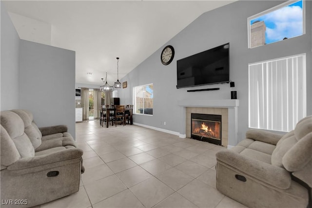 3905 Blairmoor St, North Las Vegas, NV 89032 - living room featuring high vaulted ceiling, light tile patterned flooring, baseboards, and a tiled fireplace