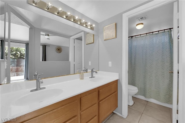 3905 Blairmoor St, North Las Vegas, NV 89032 - bathroom with toilet, tile patterned floors, double vanity, curtained shower, and a ceiling fan
