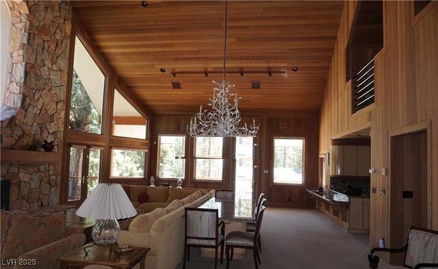 4178 Matterhorn Way, Las Vegas, NV 89124 - living room featuring high vaulted ceiling, a chandelier, wooden ceiling, light colored carpet, and wood walls