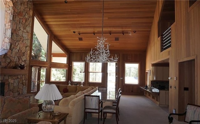 4178 Matterhorn Way, Las Vegas, NV 89124 - living area featuring high vaulted ceiling, a chandelier, wooden ceiling, wooden walls, and light colored carpet