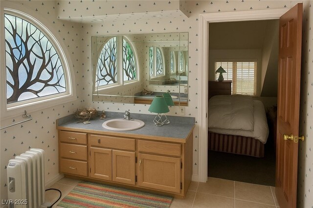 4178 Matterhorn Way, Las Vegas, NV 89124 - ensuite bathroom with radiator heating unit, tile patterned floors, vanity, and wallpapered walls