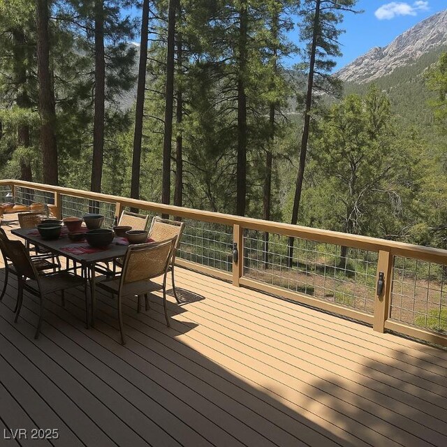 4178 Matterhorn Way, Las Vegas, NV 89124 - wooden terrace with outdoor dining area, a mountain view, and a wooded view