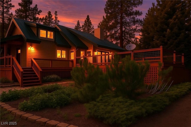 4178 Matterhorn Way, Las Vegas, NV 89124 - back of house at dusk featuring a chimney, metal roof, and a wooden deck