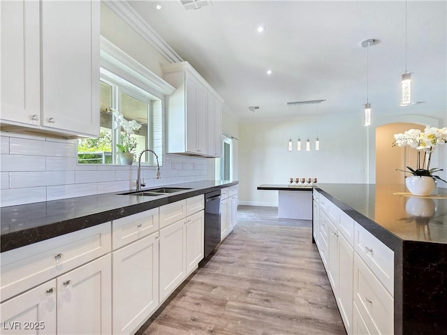 5500 Santovito St, Pahrump, NV 89061 - kitchen with a sink, dishwasher, decorative backsplash, white cabinetry, and pendant lighting