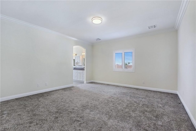 5500 Santovito St, Pahrump, NV 89061 - empty room featuring ornamental molding, carpet, arched walkways, and baseboards