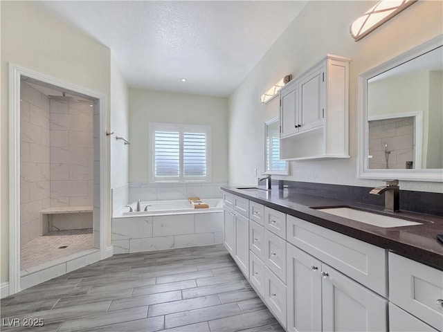 5500 Santovito St, Pahrump, NV 89061 - full bathroom with a bath, double vanity, a tile shower, and wood finish floors