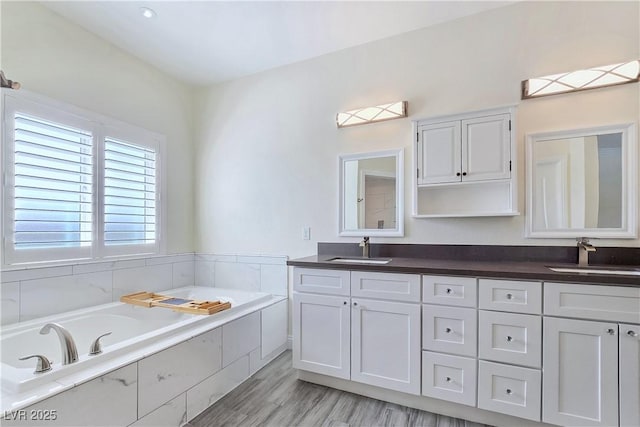 5500 Santovito St, Pahrump, NV 89061 - full bathroom with double vanity, a bath, and wood finished floors
