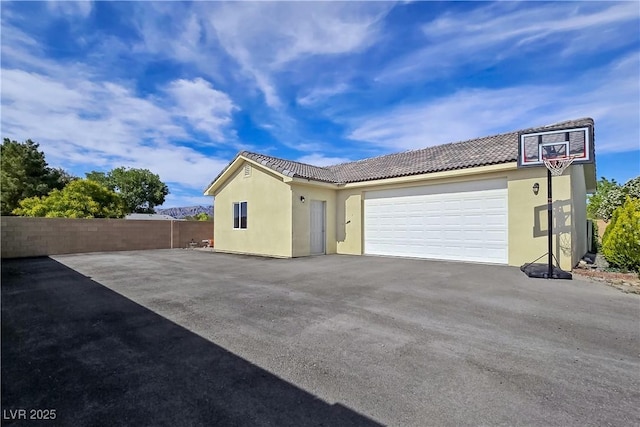 5500 Santovito St, Pahrump, NV 89061 - view of front facade featuring asphalt driveway, stucco siding, a tile roof, and an attached garage