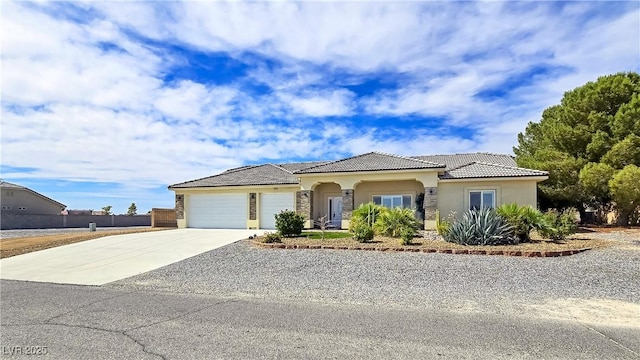 5500 Santovito St, Pahrump, NV 89061 - mediterranean / spanish-style house with stucco siding, driveway, a tiled roof, and an attached garage
