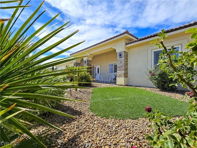 5500 Santovito St, Pahrump, NV 89061 - exterior space with stucco siding, stone siding, and a tile roof