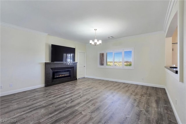 5500 Santovito St, Pahrump, NV 89061 - unfurnished living room featuring a chandelier, a glass covered fireplace, wood finished floors, crown molding, and baseboards