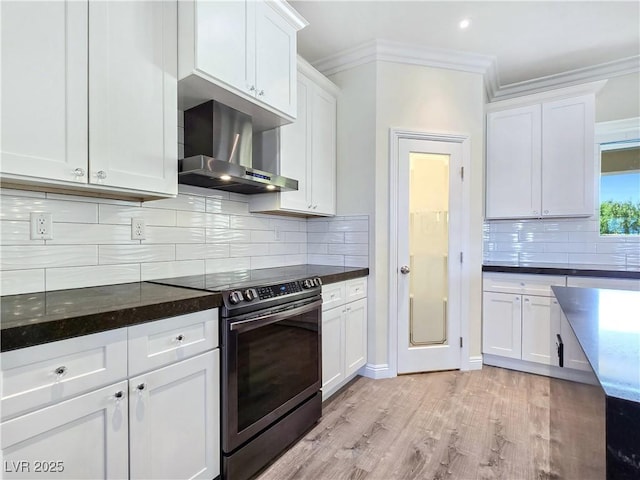5500 Santovito St, Pahrump, NV 89061 - kitchen with wall chimney exhaust hood, stainless steel range with electric cooktop, ornamental molding, light wood-type flooring, and white cabinetry
