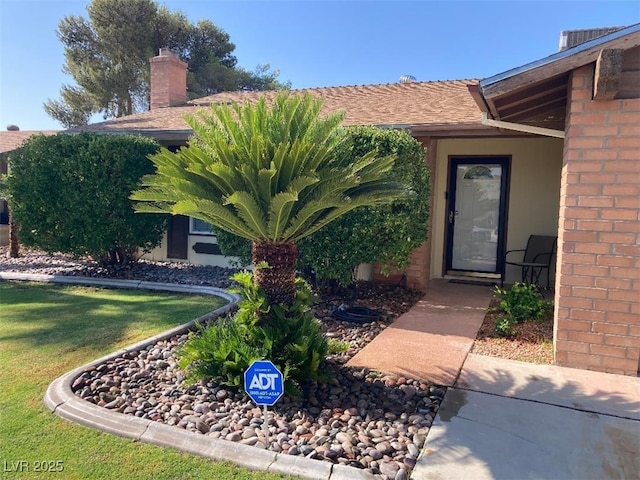 5821 Santa Catalina Ave, Las Vegas, NV 89108 - entrance to property featuring brick siding, a yard, and a chimney