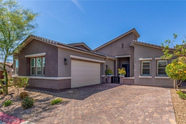8 Via Tiberina, Las Vegas, NV 89011 - view of front of home with an attached garage, stucco siding, and decorative driveway